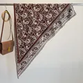 Brown and beige paisley bandana scarf belt with fringe hanging on a metal rack - 180x90cm / Coffee (SJJ-009)