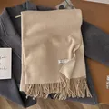 Oatmeal wool scarf with soft tassels on a grey coat for a cozy winter aesthetic - Off White