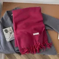 Deep rose pink 100% wool long scarf with tassels on grey coat background - Rose Red