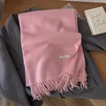 Pink wool scarf with tassel hem and metal nameplate on a dark wool coat - 195x65cm / Pink