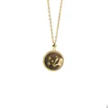 Detailed shot of gold horse relief pendant on brown shell with a cross chain necklace - Taurus + Gray Mother of Pearl