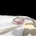 Macro shot of silver ring featuring channel set rectangular pink cubic zirconia stones - US 6 / Pink