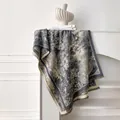 Close-up of floral toile de jouy pattern and tassel edge on warm cashmere-like shawl - 185x65cm / Gray