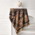 Macro detail of faux cashmere scarf featuring floral vintage prints and soft fringe edges - 185x65cm / Dark Brown