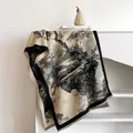 Detail of ink wash landscape print on beige cashmere-like scarf with black tassel trim - Black