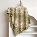 Olive and beige leopard print cashmere-feel scarf with soft tassels on a display stand - 185x65cm / Matcha Green