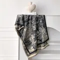 Detail of elegant black and white floral pattern scarf with decorative fringe tassels - 185x65cm / Black