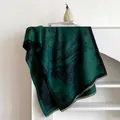Detailed close-up of dark green ink painting cashmere scarf with elegant fringe edges - Malachite green