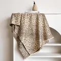 Detailed close-up of leopard jacquard scarf with soft fringe edges and premium texture - 185x65cm / Khaki
