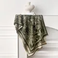 Detailed view of dark green cashmere scarf with vintage floral patterns and tassels - Olive Green