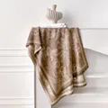 Detail of tropical plant jacquard cashmere scarf with houndstooth borders and tassels - Tan