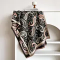 Nahaufnahme der dunkelgrauen Paisley-Stola mit feinen Fransen und weichem Strickmuster - Grau
