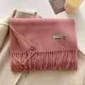Elegant 100% wool scarf in dusty pink with fringe detail on beige coat background - 211x31cm / Pink
