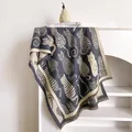 Detailed knit texture of shawl featuring abstract cat jacquard patterns and elegant fringes - 185x65cm / Gray
