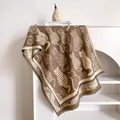 Detail of artistic cat jacquard pattern on thick knit scarf with fine tassel fringe edge - 185x65cm / Camel