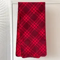 Close-up of soft red plaid scarf texture with high-quality stitching on white hanger - Red