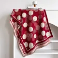 Detail of red and cream polka dot scarf with cashmere-like texture and fringed edges - Dark Red
