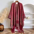 Elegant burgundy paisley cashmere scarf with tassels hanging on a wooden hanger - 145x130cm / Red (BXS-459)