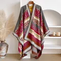 Detail of bohemian knit shawl featuring ethnic geometric patterns and tassels - Brick Red