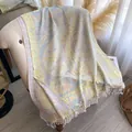 Detailed view of paisley jacquard pattern and soft white fringe tassels on pastel shawl - Off White