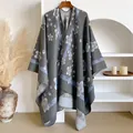 Close-up of grey knit shawl featuring light blue cherry blossom prints and edge stitching - Tops / 130x152cm / Blue