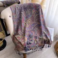 Detail of intricate Paisley pattern scarf with long fringe on a light armchair - 195x70cm / Purple