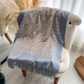 Light blue cashmere shawl with gold floral embroidery and tassels on a cozy chair - 200x70cm / Gray