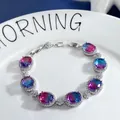 Macro view of gradient gemstone bracelet with oval stones and white zircon details - Colorful