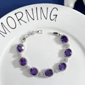 Detail of silver bracelet with purple oval gemstones and sparkling cubic zirconia clusters - Purple