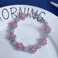 Macro detail of silver flower bracelet with sparkling pink and white zirconia stones - Transparent Pink