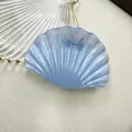 Elegant light blue shell hair claw with a pearlescent finish and metallic spring - Ocean Blue