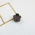 Matte dark brown five-petal flower mini hair claw clip displayed on a gold stand - Dark Gray
