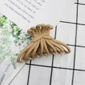 Matte beige hair claw clip with crossed ribbon design on minimalist checkered background - Khaki