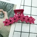 Vibrant rose pink star-shaped hair claw clip with a hollow geometric pentagon design - Rose Red