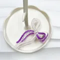 Bow-shaped hair claw clip in transparent acrylic with elegant purple accents - White + Purple