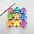 Flat lay of nine colorful 3cm flower hair clips in a variety of vibrant candy colors - Five-Petal Flower (Mixed Colors)