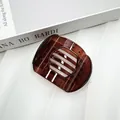 Flat round amber brown translucent resin hair clip with elegant hollow curved design - Glossy Red Coffee