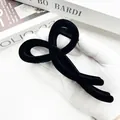 Elegant large black flocked velvet bow hair claw clip for women held by gloved hand - Bow Style (Style Two)
