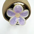 Detailed close-up of a purple jelly frangipani flower hair claw clip with yellow accents - Purple with Yellow Trim
