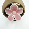 Macro view of jelly pink flower hair claw with white edges and glossy resin finish - Pink with Yellow Trim