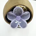 Detail of lavender jelly frangipani hair claw clip with glossy resin finish - Gray with Purple Trim