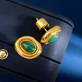Close-up of vintage oval gold earrings with green malachite stones on blue jewelry box - Stud Earrings / Gold Malachite Earrings