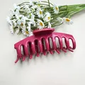 Large hot pink soft silicone hair claw clip for women shown with daisy flowers - Soft Silicone Bone Red