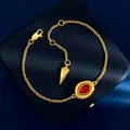 Elegant gold chain bracelet with oval red stone and tapered metal pendant on blue velvet - Gold Red Agate Bracelet