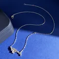 Detail shot of bow-shaped pendant with sparkling crystals and fine silver link chain - Silver