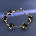 Elegant gold chain bracelet featuring five black and white dual-tone crystal pendants - Gold (Black + Clear)