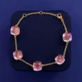 Close-up of five square pink crystal stones on a delicate gold-plated adjustable chain - Gold Tone + Clear Purple
