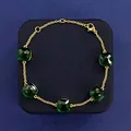 Elegant gold bracelet featuring five square-cut emerald green crystals for women - Gold + Peacock Green