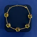 Minimalist gold chain bracelet featuring five square-cut yellow crystal gemstones - Gold Tone + Grey