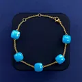 Gold chain bracelet featuring five square sky blue gemstones with a secure lobster clasp - Gold Tone + Turquoise Blue